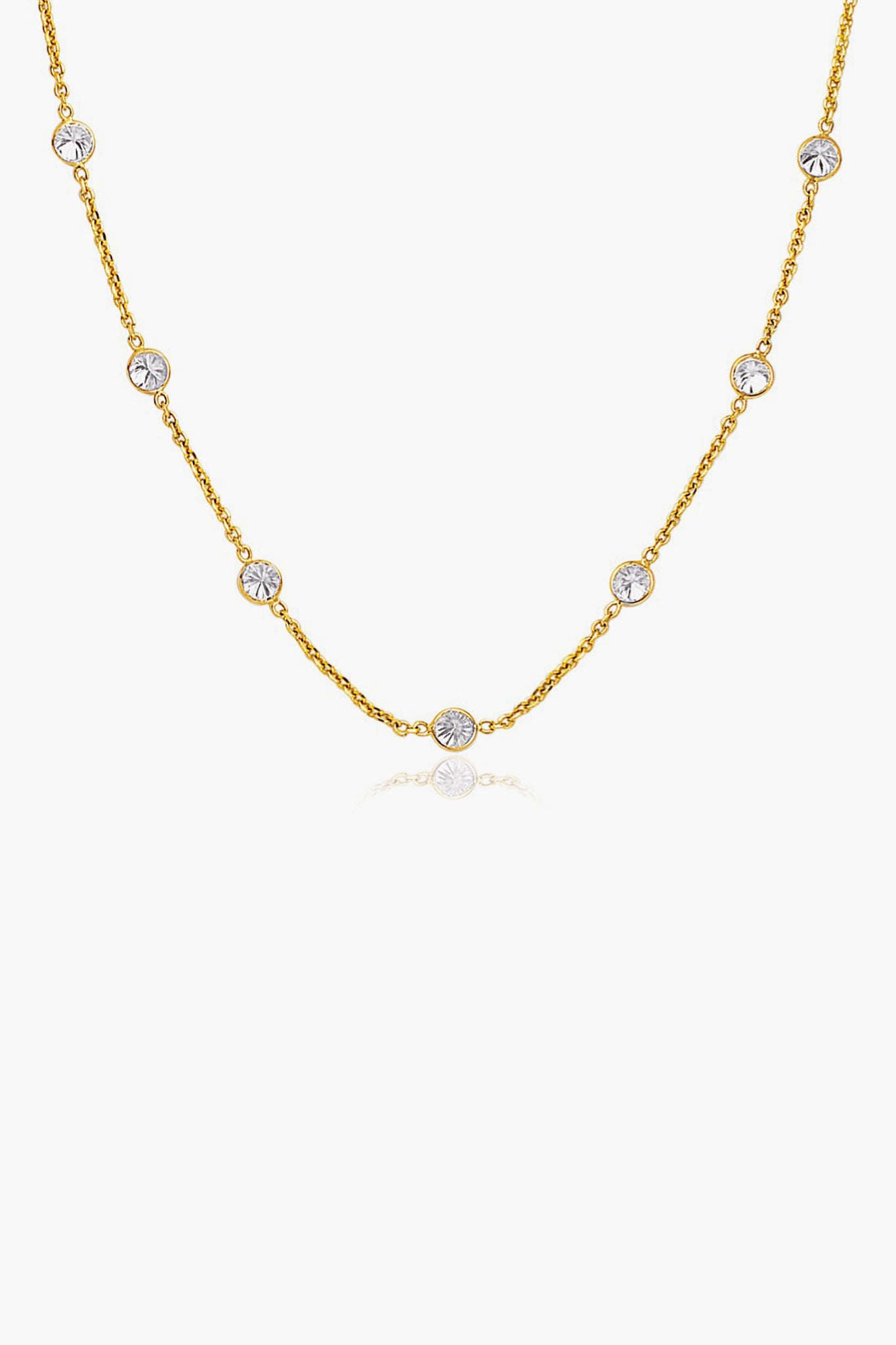 Tuckernuck Fine Jewelry’s 14k gold chain necklace features evenly spaced round white gemstones set in bezels—an everyday essential.