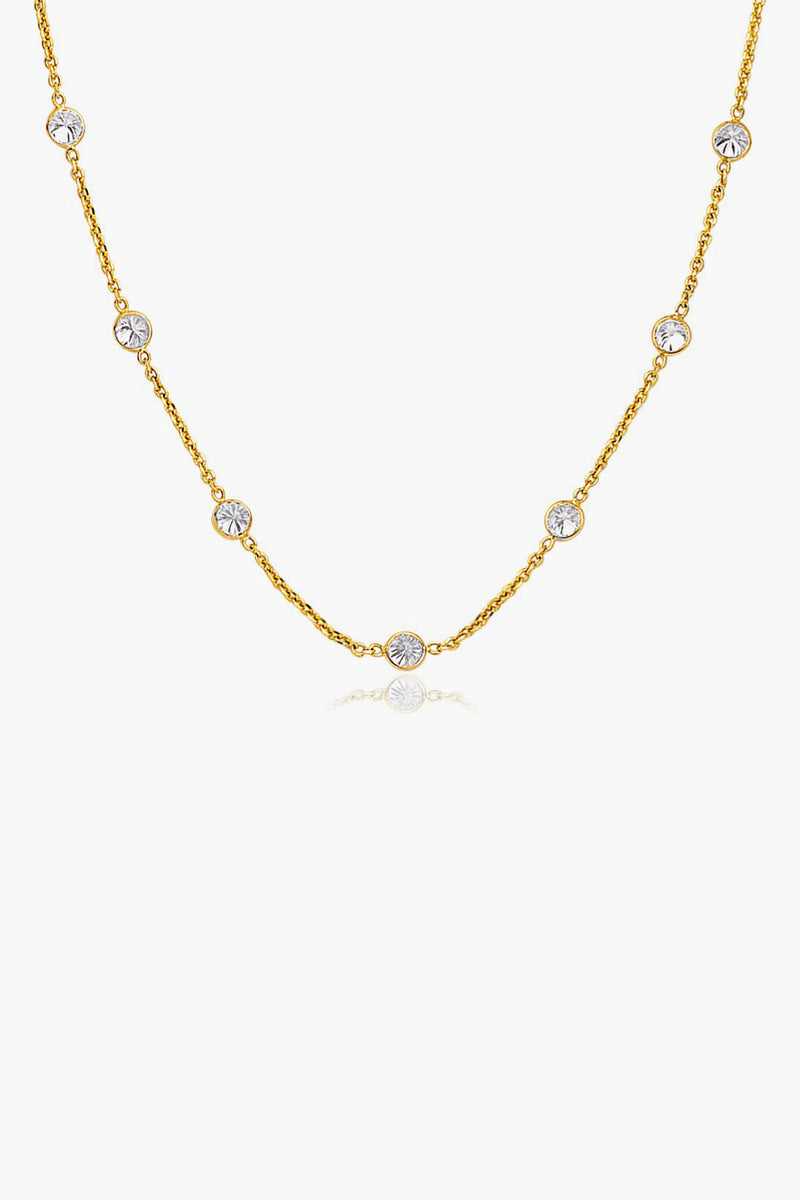Tuckernuck Fine Jewelry’s 14k gold chain necklace features evenly spaced round white gemstones set in bezels—an everyday essential.